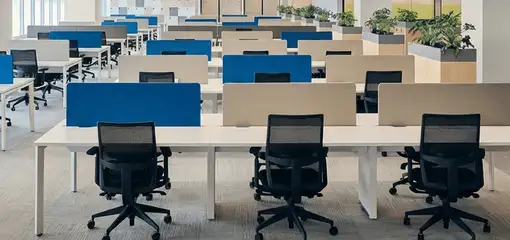 Modern open-plan office space featuring clean workstations, ergonomic chairs, and sanitized carpets provided by professional office cleaning services in Albany, NY.