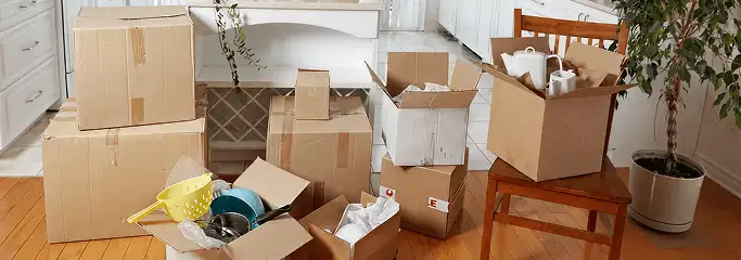 Packed moving boxes and household items in a kitchen before move-out or move-in cleaning, Albany, NY.